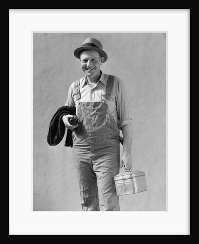 1930s Man In Work Clothes Overalls Holding Lunch Box Thermos Bottle And Sweater by Anonymous