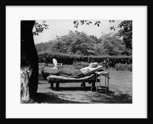 1950s Elderly Man In Backyard Stretched Out On Lounge Chair Under Tree by Anonymous