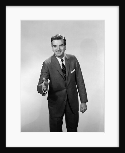 1960s Salesman Or Businessman Leaning Forward Extending Hand For Handshake by Anonymous