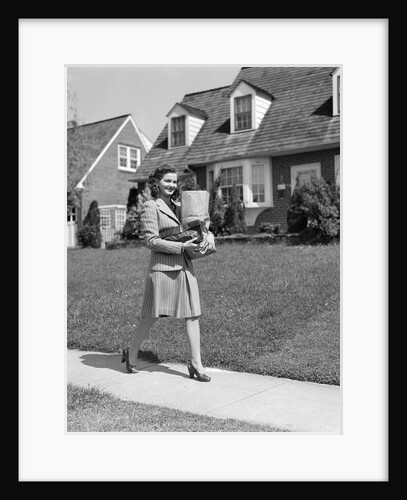 1940s Woman Walking Shopping Carrying Grocery Bag On Suburban House Sidewalk by Anonymous
