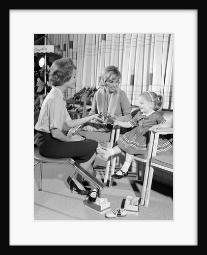 1960s Mother Daughter Shoe Shopping Saleswoman Showing Patent Leather Shoe To Girl by Anonymous