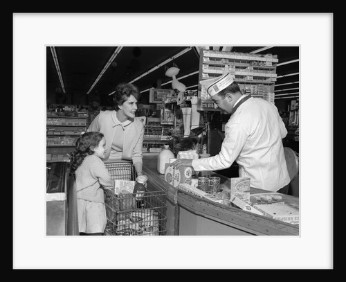 1960s Mother Daughter Unload Grocery Cart At Supermarket Checkout Counter by Anonymous