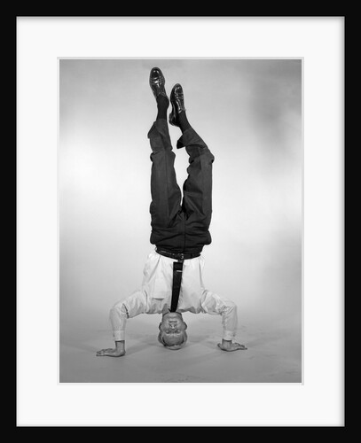 1960s Man In Shirt and Tie Standing On Head by Anonymous