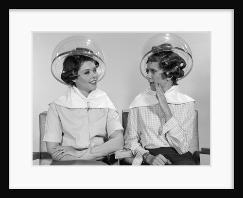1960s Two Women Sitting Together Gossiping Under Hairdresser Hair Dryer by Anonymous