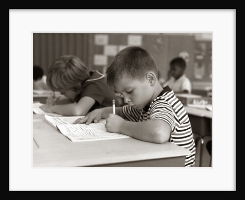 1960s Boy Striped T-Shirt Elementary School Classroom Sitting Desk Writing Test by Anonymous