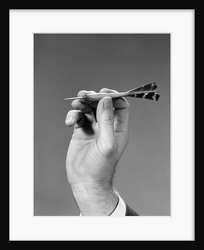 1960s 1970s Hand Close-Up Holding About To Throw A Sharp Pointed Dart by Anonymous