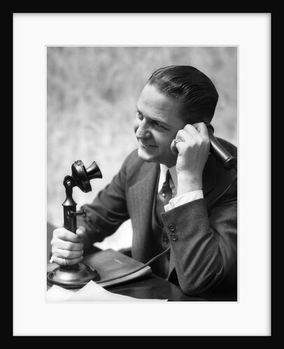 1920s Businessman Talking Into Candlestick Telephone by Anonymous