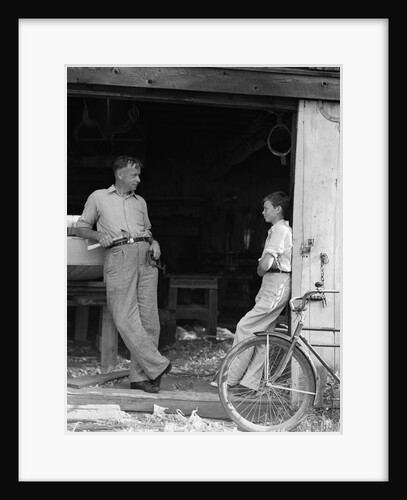 1930s Man Father Holding Hand Tools Talking To Boy Son Leaning In Doorway Of Boat Shed by Anonymous