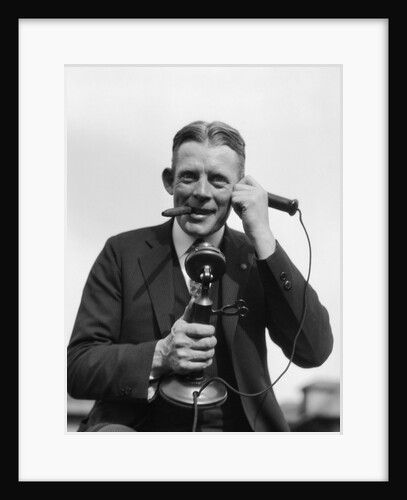 1920s Portrait Of Businessman Talking On Candlestick Phone Smoking Cigar Office Indoor by Anonymous
