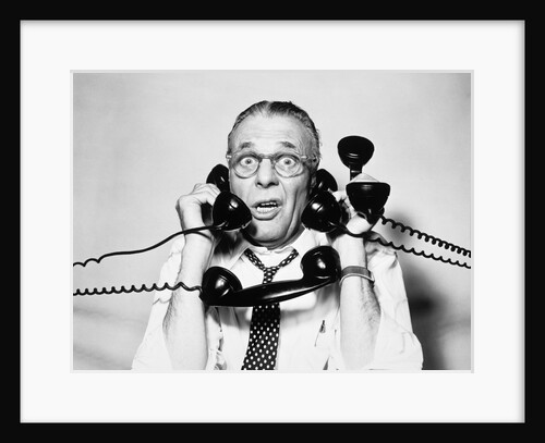 1950s 1960s Portrait Of Frazzled Businessman Trying To Answer Four Black Telephones Phones At Once by Anonymous
