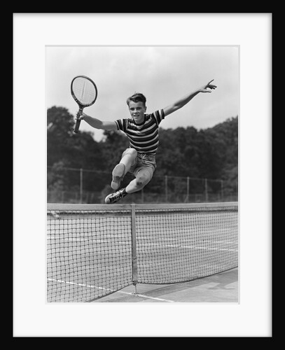 1930s Teenage Boy Tennis Player Jumping Net With Racket In Hand by Anonymous