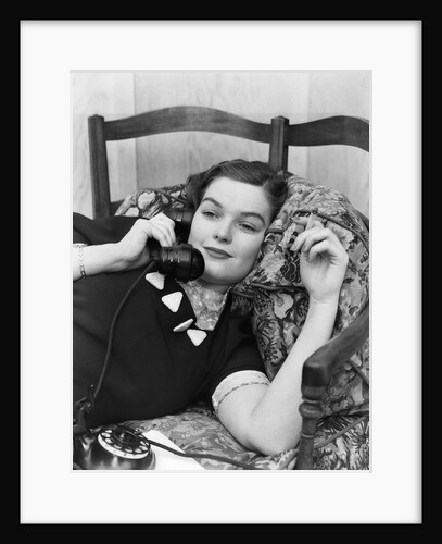 1930s Young Brunette Woman Reclining On Pillows Cigarette In Hand Talking On Telephone by Anonymous