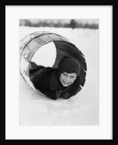 1920s Boy Playing Lying In Snow Rolling In Wooden Barrel by Anonymous