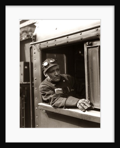 1920s 1930s 1940s Railroad Train Engineer Looking Out Window Of Locomotive Cab Driving The Steam Engine by Anonymous