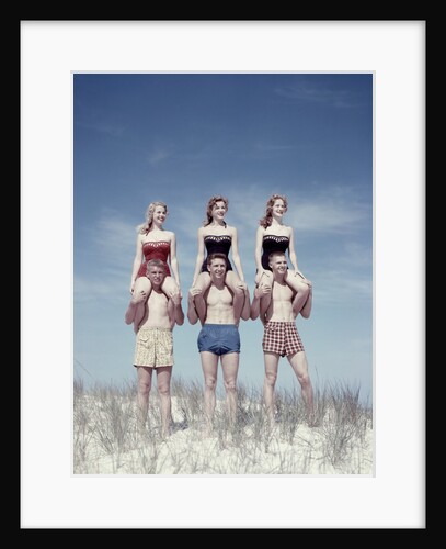 1950s 3 Teen Couples Standing On Sand Dune Girls Sitting On Guys Shoulders by Anonymous