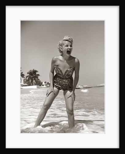 1950s Laughing Woman In Strapless Low Cut Bathing Suit Swim Wear Wading Up To Ankles In Surf by Anonymous