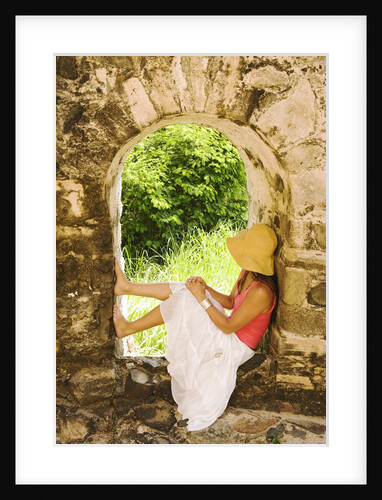 Young Woman Sitting in Window in Old Stone Wall by Anonymous