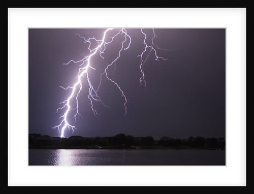 Lightning Striking Ground Near Residential Lake by Anonymous