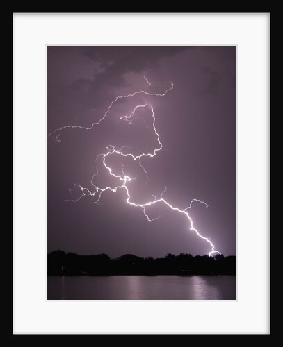 Lightning Striking Ground Near Residential Lake by Anonymous