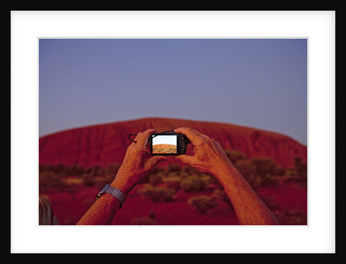 Tourist photographing Ayers Rock in the Australian Outback by Anonymous