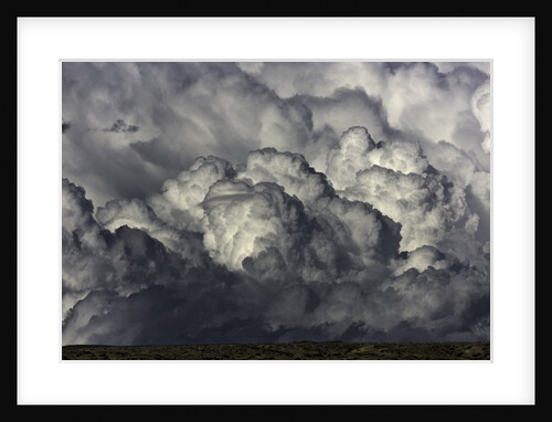Heavy cumulus clouds above sagebrush desert by Anonymous