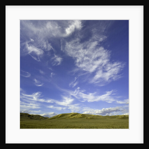 Lofty cumulus and cirrus clouds over sagebrush prairie by Anonymous