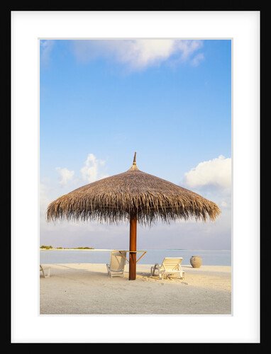 Beach chairs and umbrella at the beach by Anonymous