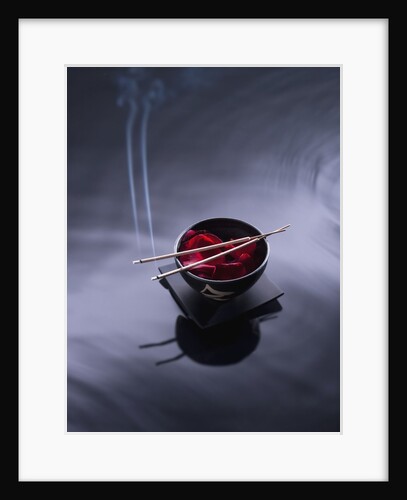 Burning incense on top of bowl of petals by Anonymous