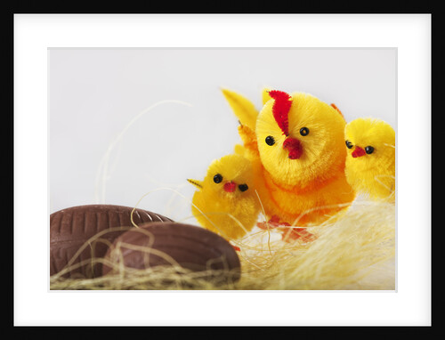 Toy chickens looking at chocolate eggs by Anonymous