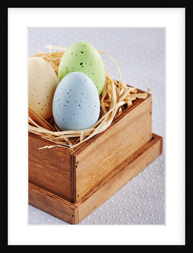 Dyed Easters eggs in wooden box with straw by Anonymous
