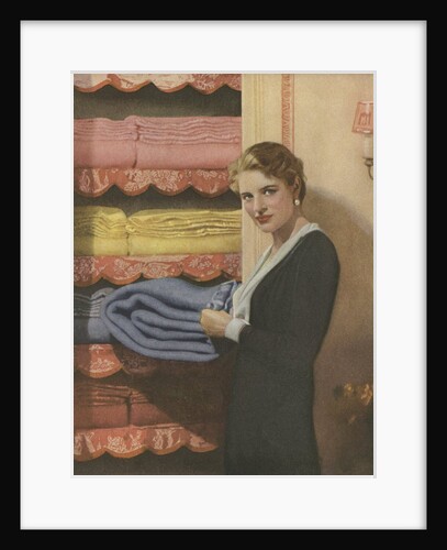 Woman puting away blanket in linen closet by Anonymous