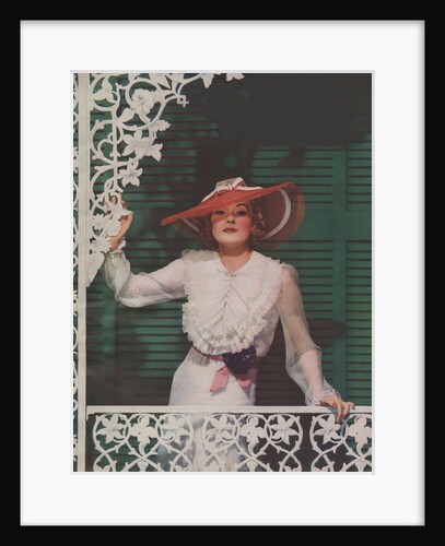 Woman with picture hat on front porch by Anonymous