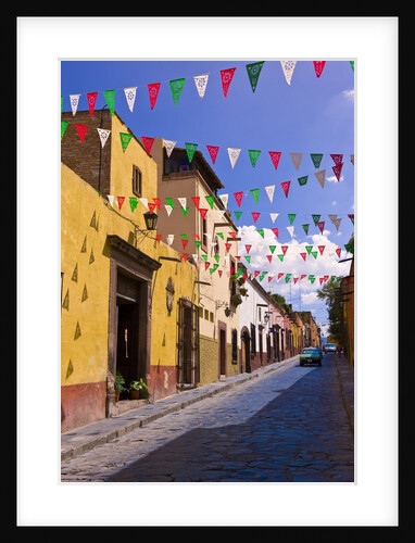 Street in San Miguel de Allende decorated with colorful flags by Anonymous
