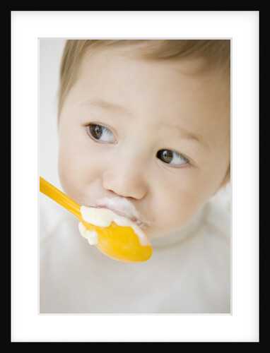 Boy having ice cream with spoon by Anonymous