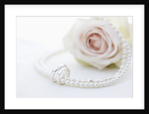 Necklace, wedding rings and flower by Anonymous