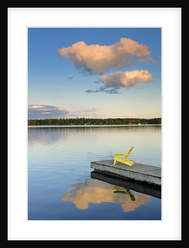 Clouds reflected in Silent Lake with Muskoka chair on dock by Anonymous