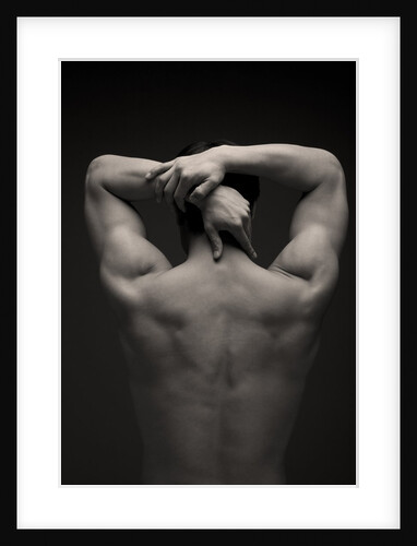 Rear view of a male stretching his arm behind his head by Anonymous