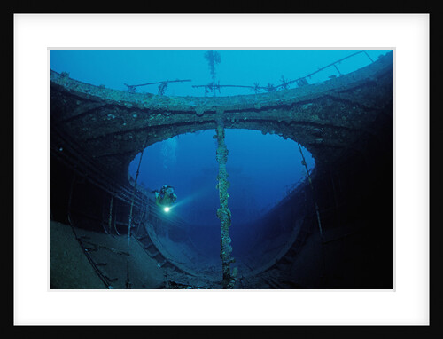 Scuba diver exploring a shipwreck, Papua New Guinea, Coral Sea. by Anonymous