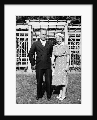 Middle aged couple pose on the lawn, ca. 1939 by Anonymous