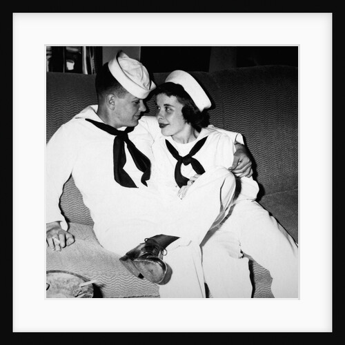 A sailor poses with his"sailor" girlfriend at a party, ca. 1955 by Anonymous