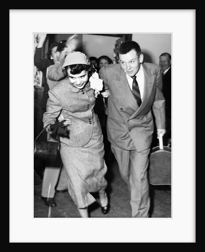 A couple leave their wedding and onto their honeymoon, ca. 1955 by Anonymous
