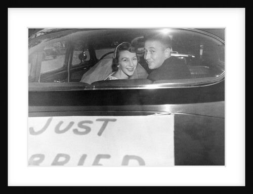 A couple peers out of the back window on their wedding day, ca. 1953 by Anonymous