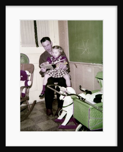 A father reads to his 4 year old daughter, ca. 1957 by Anonymous
