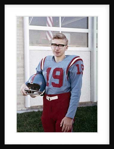 Fifteen year old high school football player portrait outside the school, ca. 1961 by Anonymous