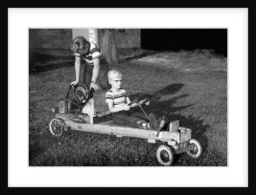 Brothers play with their homemade go cart, ca. 1955 by Anonymous