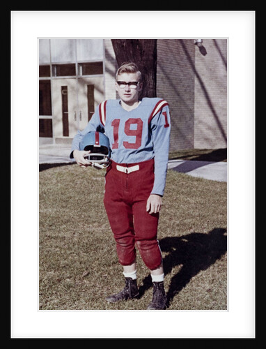 Fifteen year old high school football player portrait outside the school, ca. 1961 by Anonymous