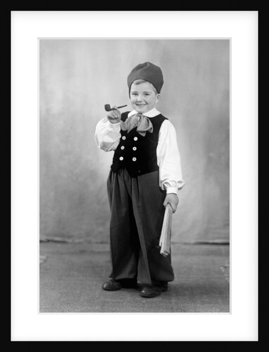Six year old boy in Bavarian costume holds a pipe, ca. 1947 by Anonymous