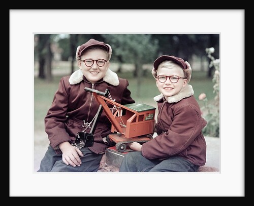 Two brothers play with a Buddy L steam shovel toy in Wisconsin, ca. 1953 by Anonymous