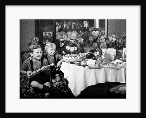 Brothers, ages 8 and 3, pose with birthday presents, ca. 1949 by Anonymous