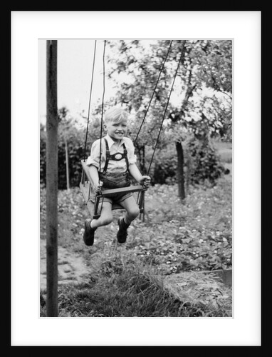 Four year old boy on a swing, ca. 1950 by Anonymous